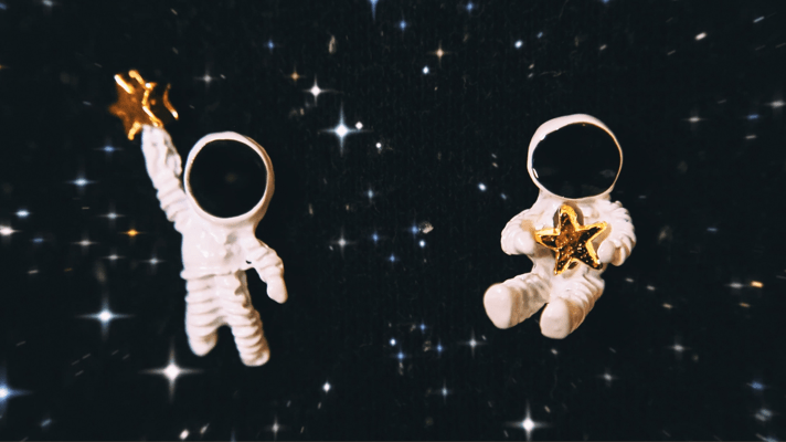 Kid Astronaut suits in space holding a star