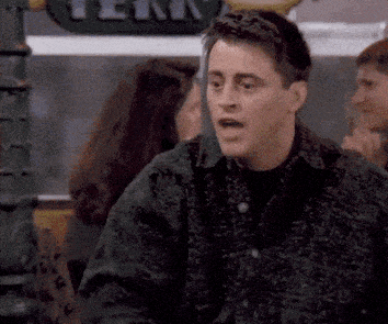 Joey from Friends covering his mouth apparently in shame. 