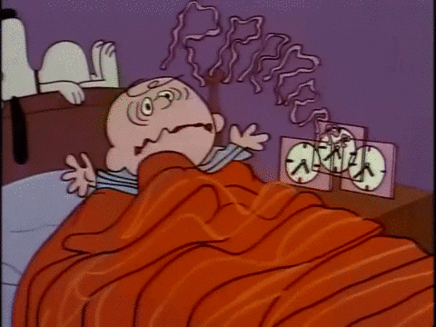 Charlie Brown waking up to an alarm clock.